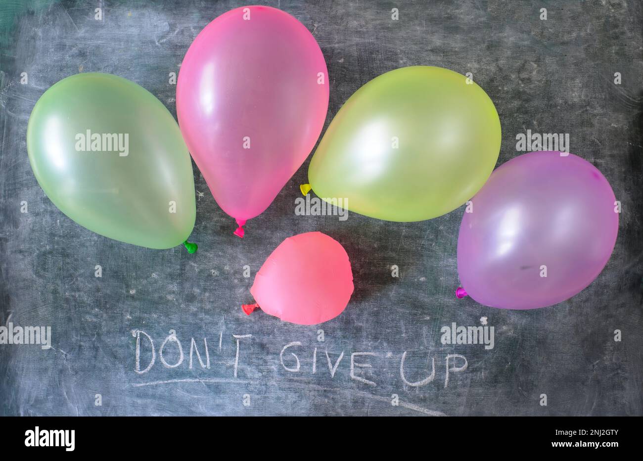 Geschäftskonzept, niemals aufgeben, vier Ballons und eine Wohnung Stockfoto