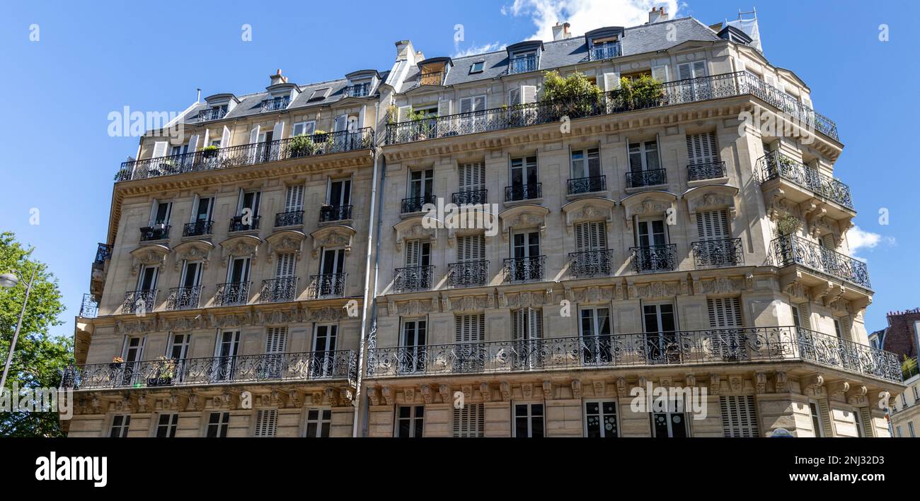 Ein Gebäude im Haussmann-Stil im Zentrum von Paris mit seiner unverwechselbaren Fassade, schmiedeeisernen Balkonen und hohen Fenstern. Stockfoto