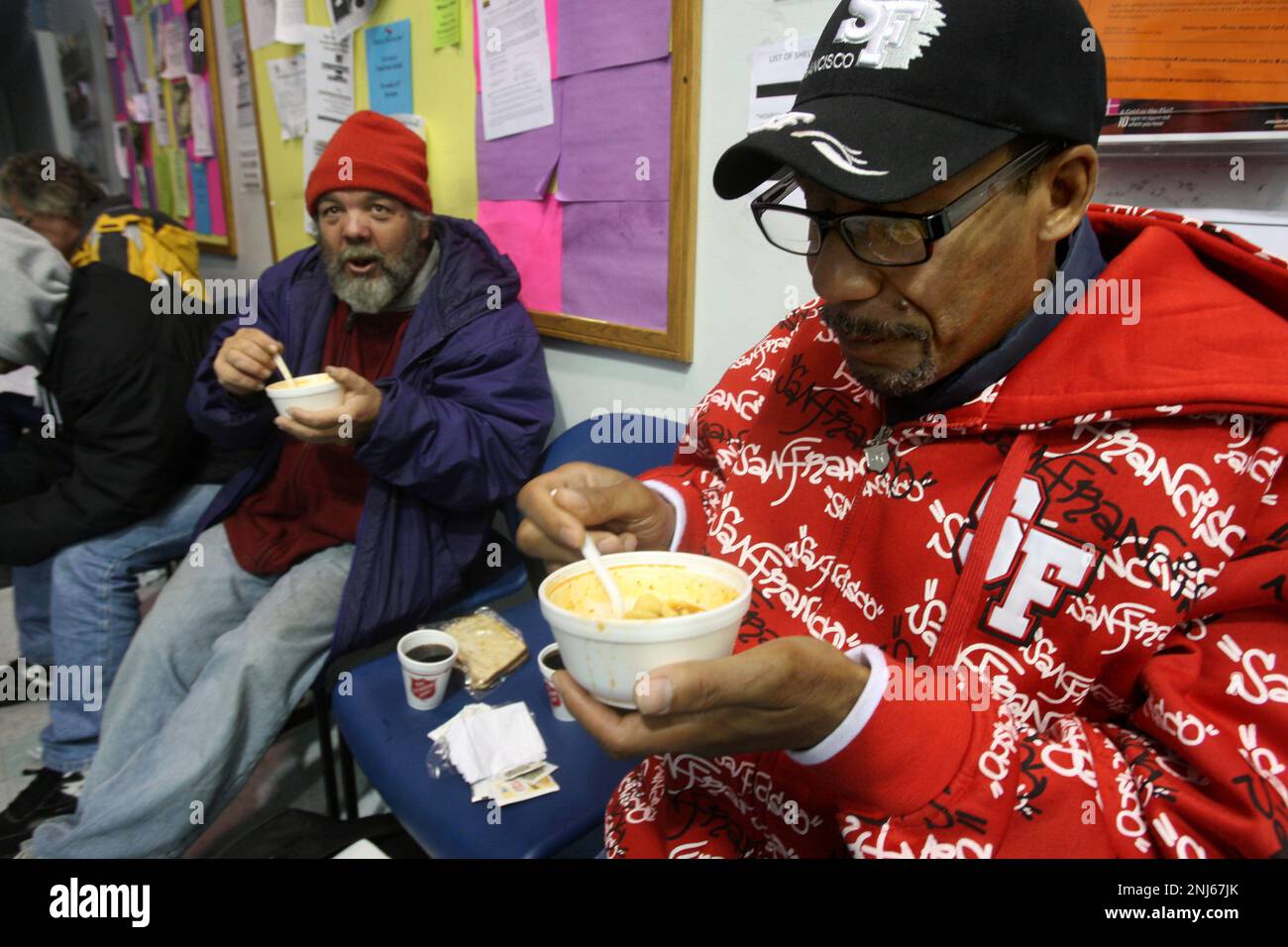 Ladoris Perkins (right) and Poncho (left) eat soup from the Salvation Army on Golden Gate at Leavenworth streets in San Francisco, Calif, on Friday, December 12, 2008. (Liz Hafalia/San Francisco Chronicle via AP) Stockfoto