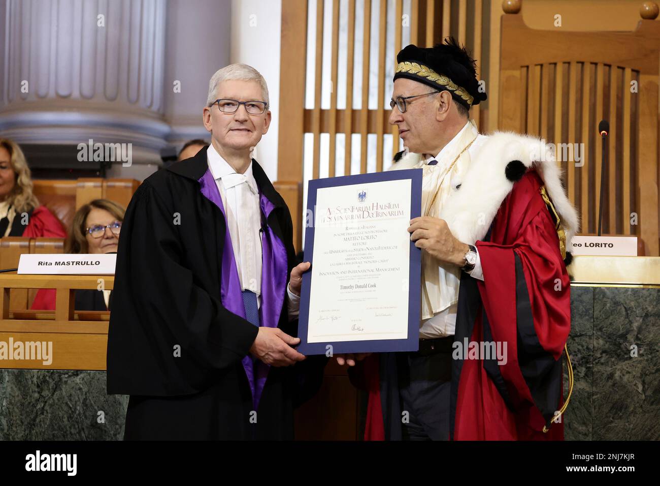 Apple's CEO Tim Cook, left, receives the Honorary Degree in Innovation ...