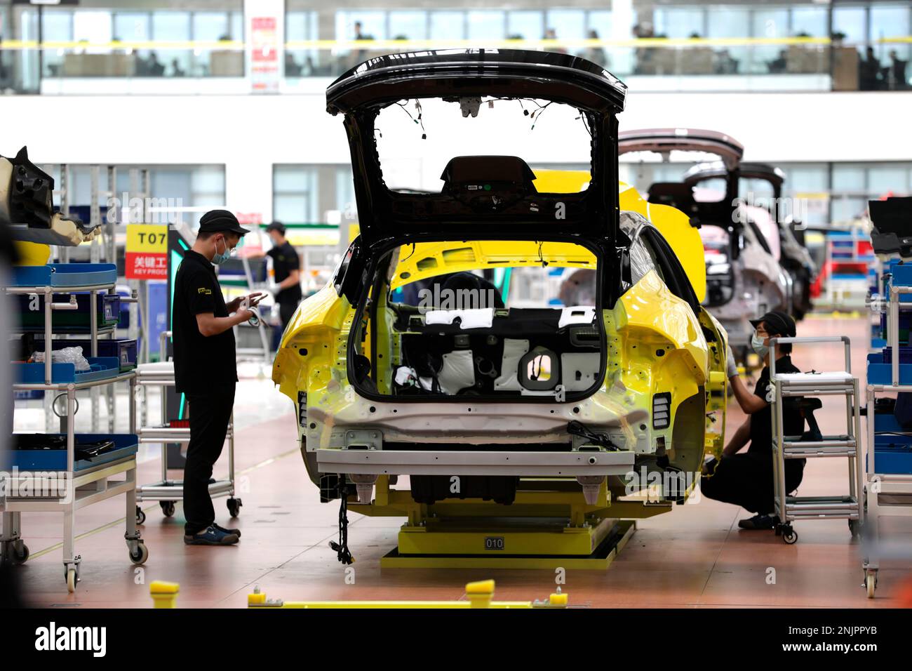Workers assemble Lotus NYO Eletre electric SUVs at the smart plant of