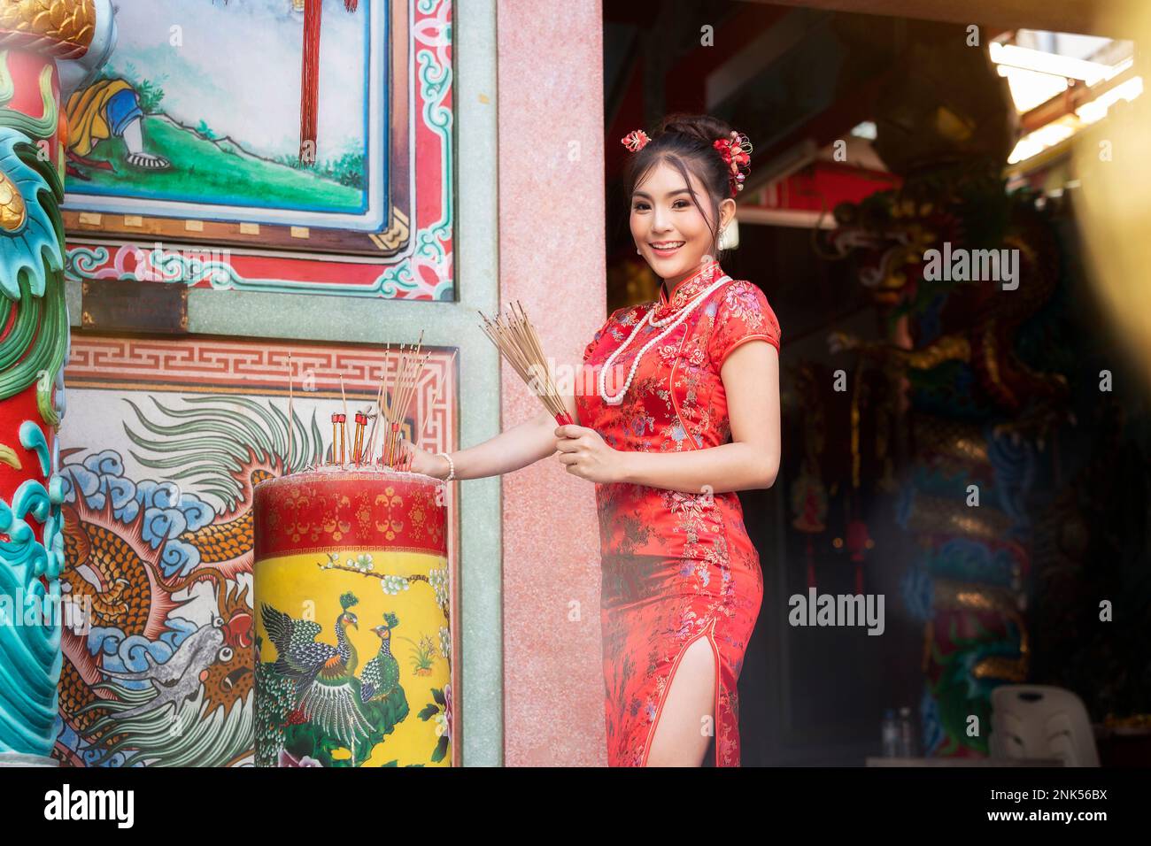 Konzept zur Feier des chinesischen Neujahrs, Vegetarian Festival : Chinesische Frau in rotem Cheongsam-Kleid mit Weihrauch ehrt chinesischen gott im Shrin Stockfoto