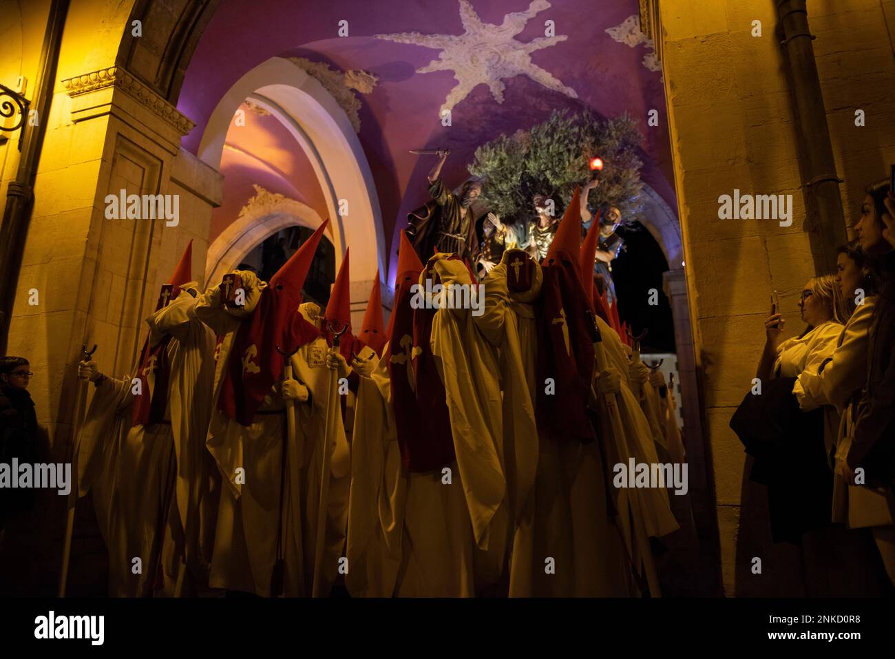 Several Nazarenes carry the paso of the Religious-Benevolent ...