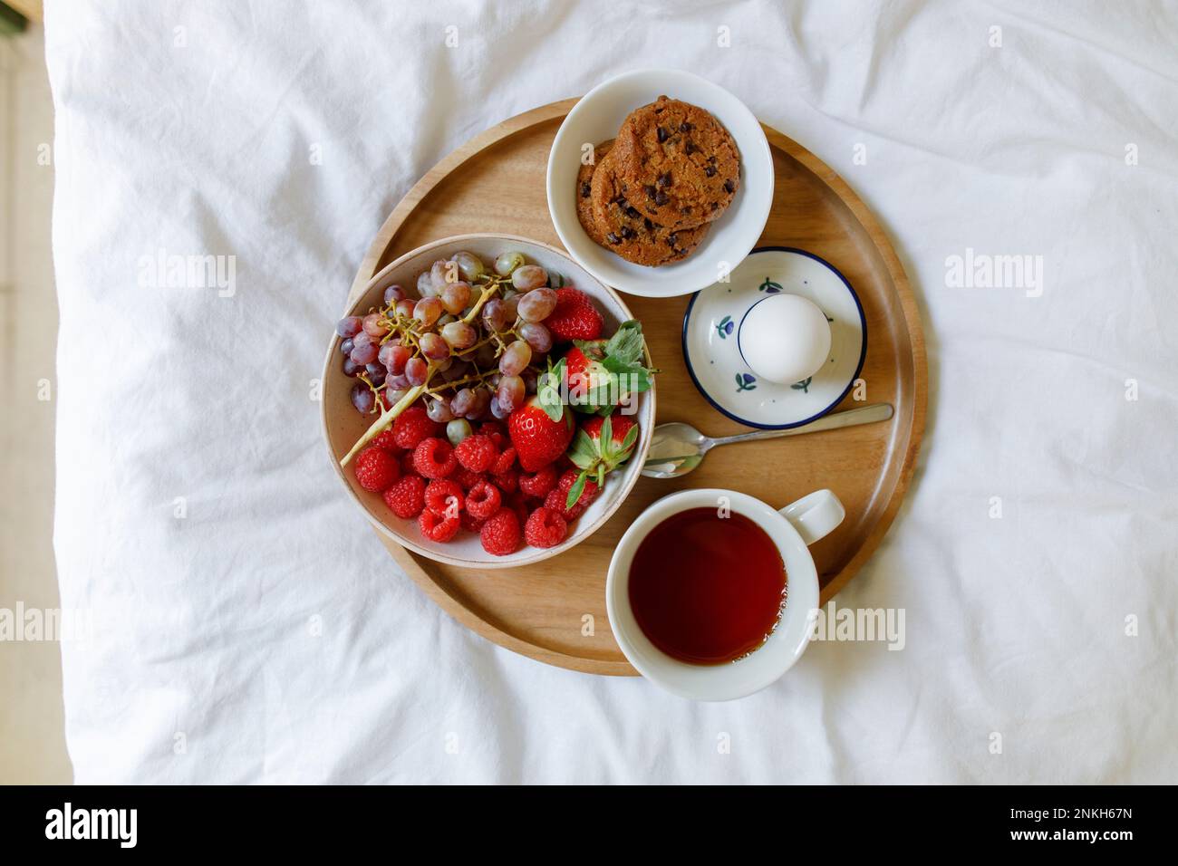 Frühstück auf einem Holztablett im Bett zu Hause Stockfoto