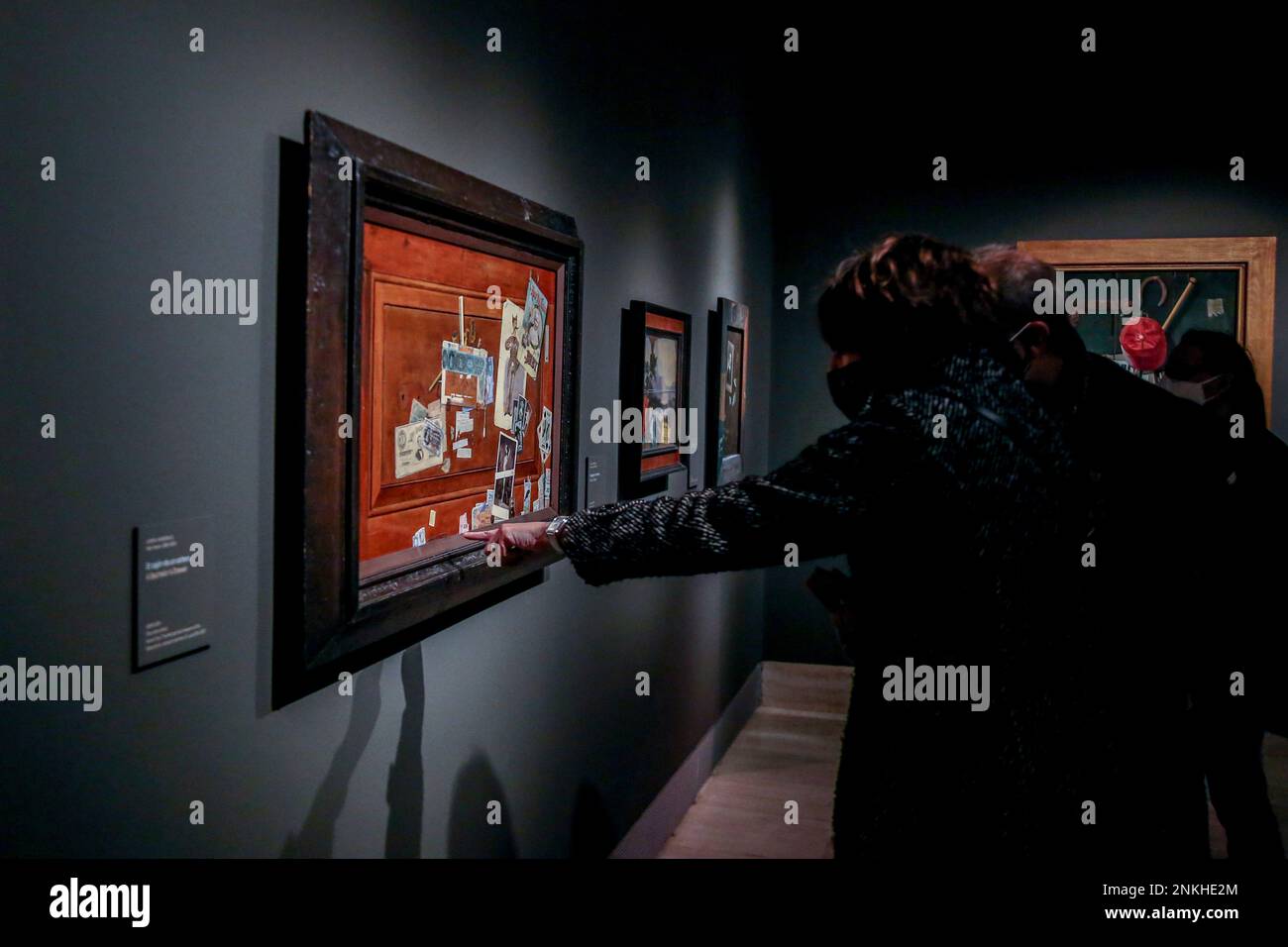 Visitors contemplate the works that are part of the exhibition ...