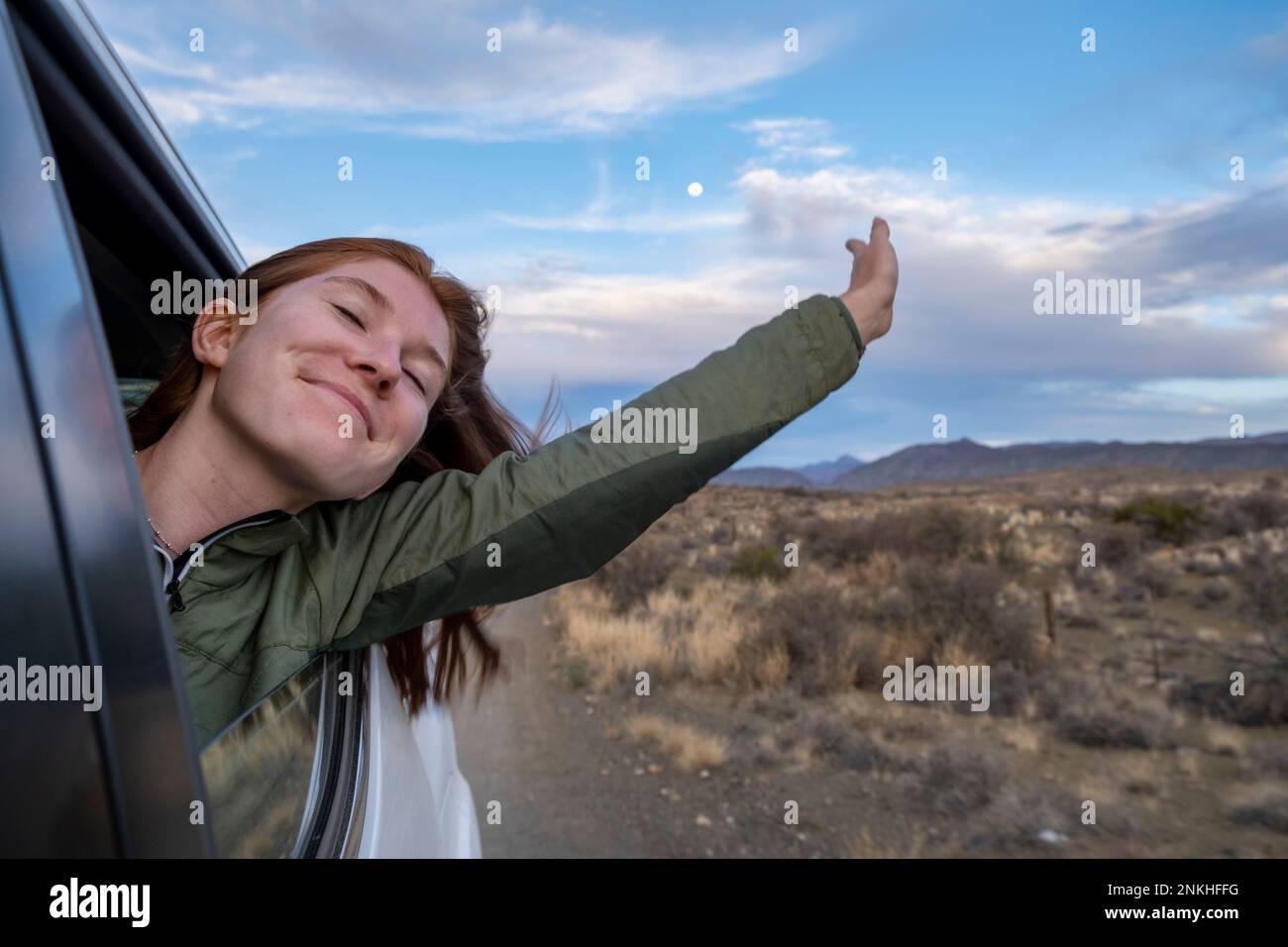Südafrika, Westkap-Provinz, Mädchen lehnt sich aus dem Fenster eines fahrenden Autos Stockfoto