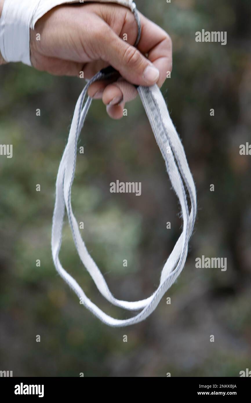 A sling is made of nylon woven into a flat tube an inch across. It is