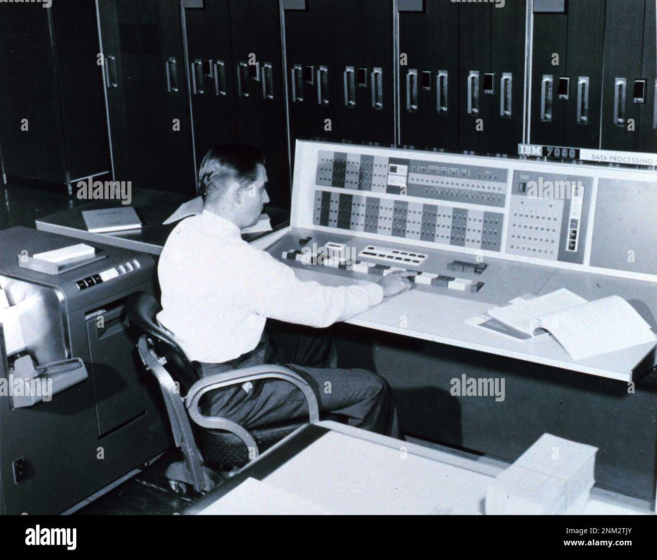 Ein Meteorologe an der Konsole des IBM 7090-Rechners in der Joint Numerical Weather Prediction Unit. Dieser Computer wurde verwendet, um Wetterdaten für kurz- und Langstreckenprognosen, Analysen und Forschungszwecke zu verarbeiten. 1965 Stockfoto