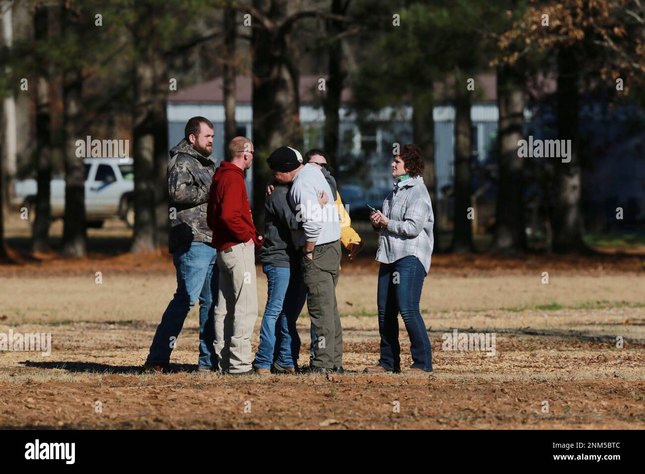 A member of the Pontotoc County Sheriff Department hugs Amber Miskelly after informing her that