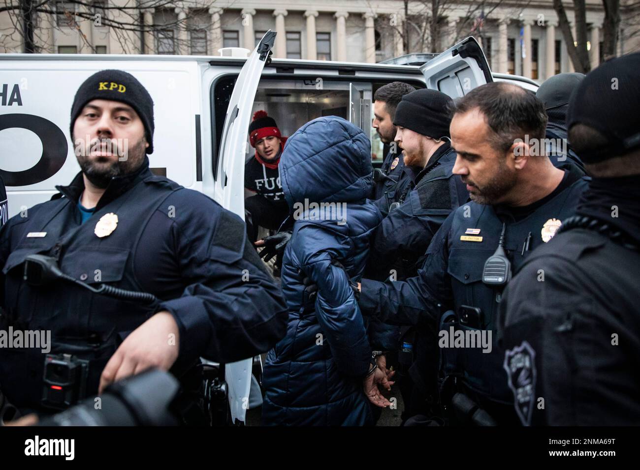 Two protesters are detained by Kenosha police after a fight broke out on the steps of the Kenosha County Courthouse in Kenosha, Wis. Wednesday, Nov. 17, 2021. Kyle Rittenhouse is accused of killing two people and wounding a third during a protest over police brutality in Kenosha, last year. (Ashlee Rezin /Chicago Sun-Times via AP) Stockfoto