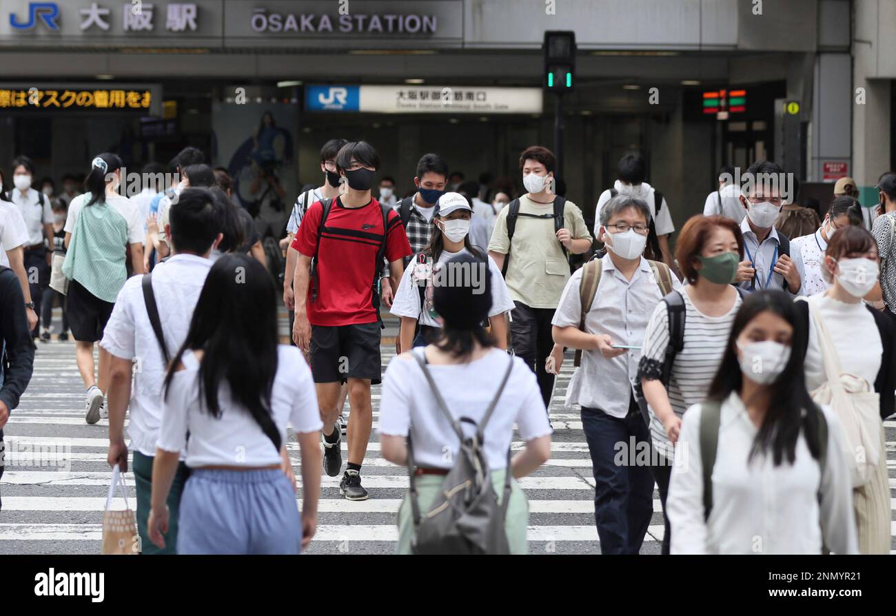 People wearing face masks are seen in front of Osaka station in Osaka
