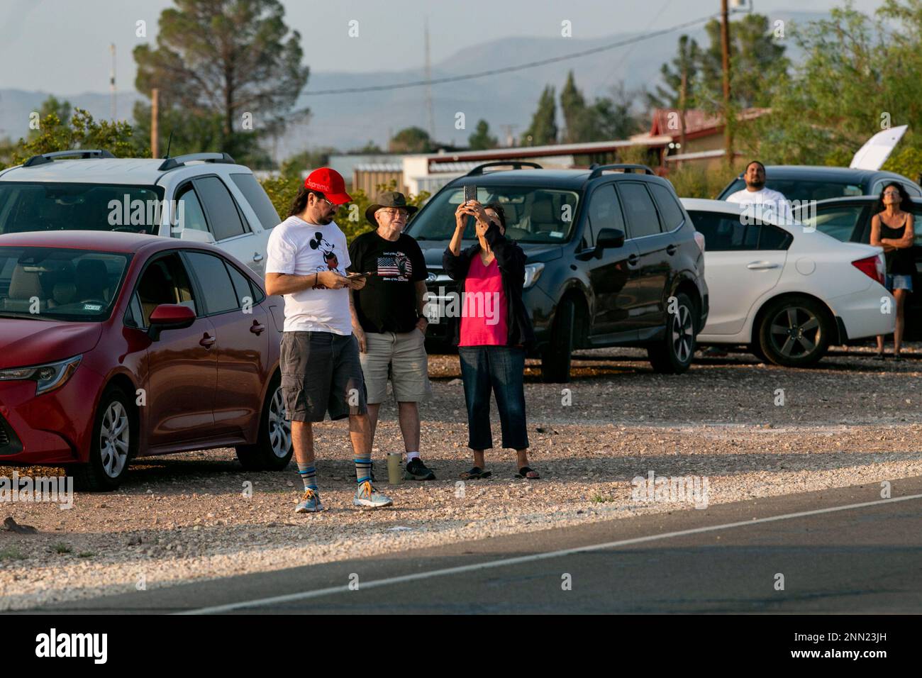 Spectators watch Blue Origin's New Shepard rocket lift off from a