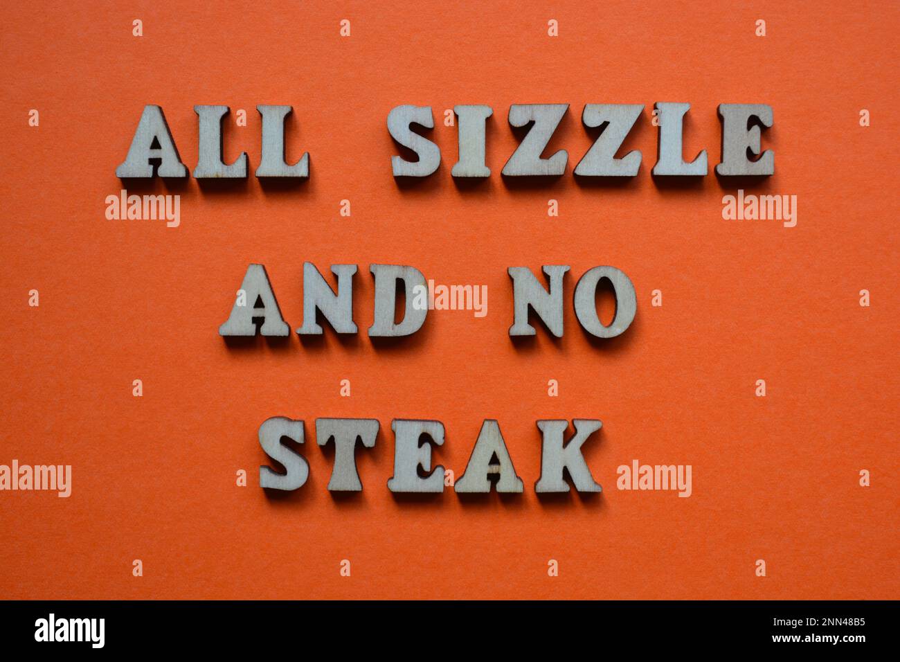 Alle Sizzle und kein Steak, Satz in hölzernen Buchstaben isoliert auf orangefarbenem Hintergrund Stockfoto