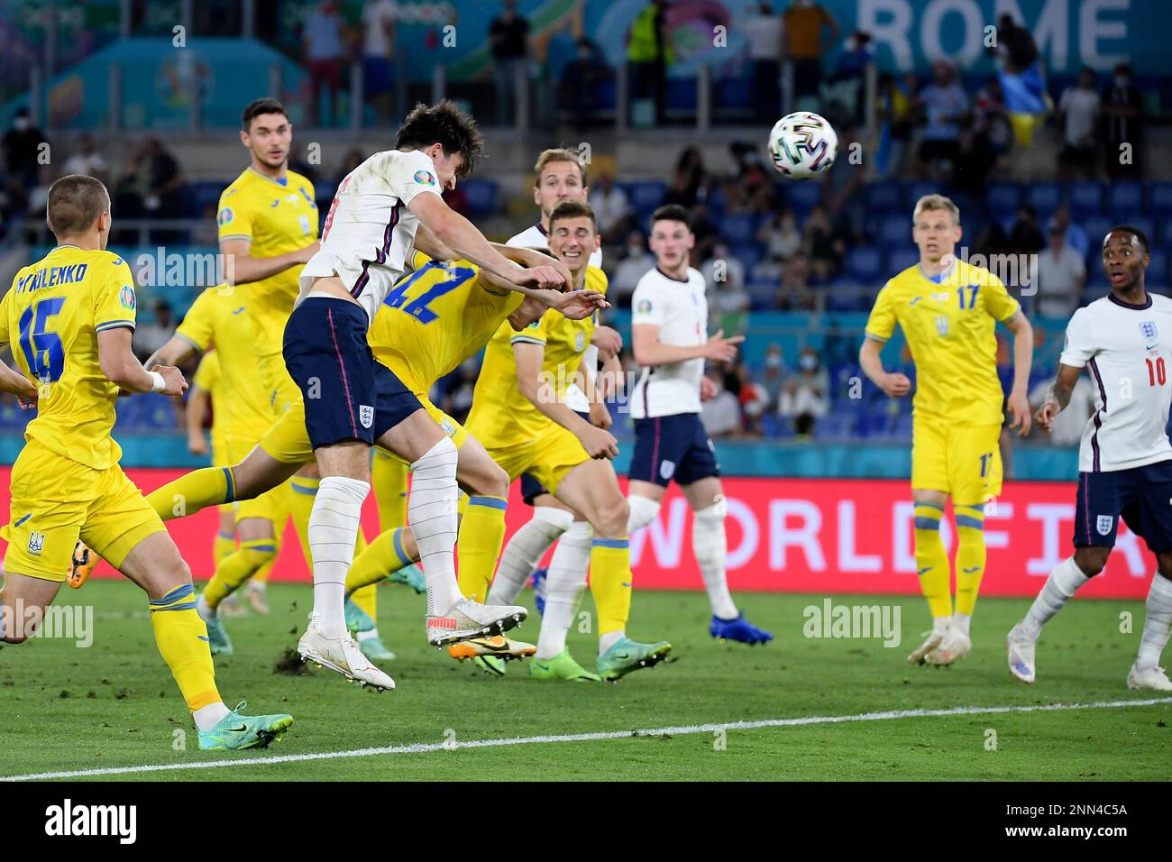 England's Harry Maguire, foreground 2nd left, scores his side's second goal during the Euro 2020 soccer championship quarterfinal match between Ukraine and England at the Olympic stadium in Rome, Saturday, July 3, 2021. (AP Photo/Ettore Ferrari, Pool) Stockfoto
