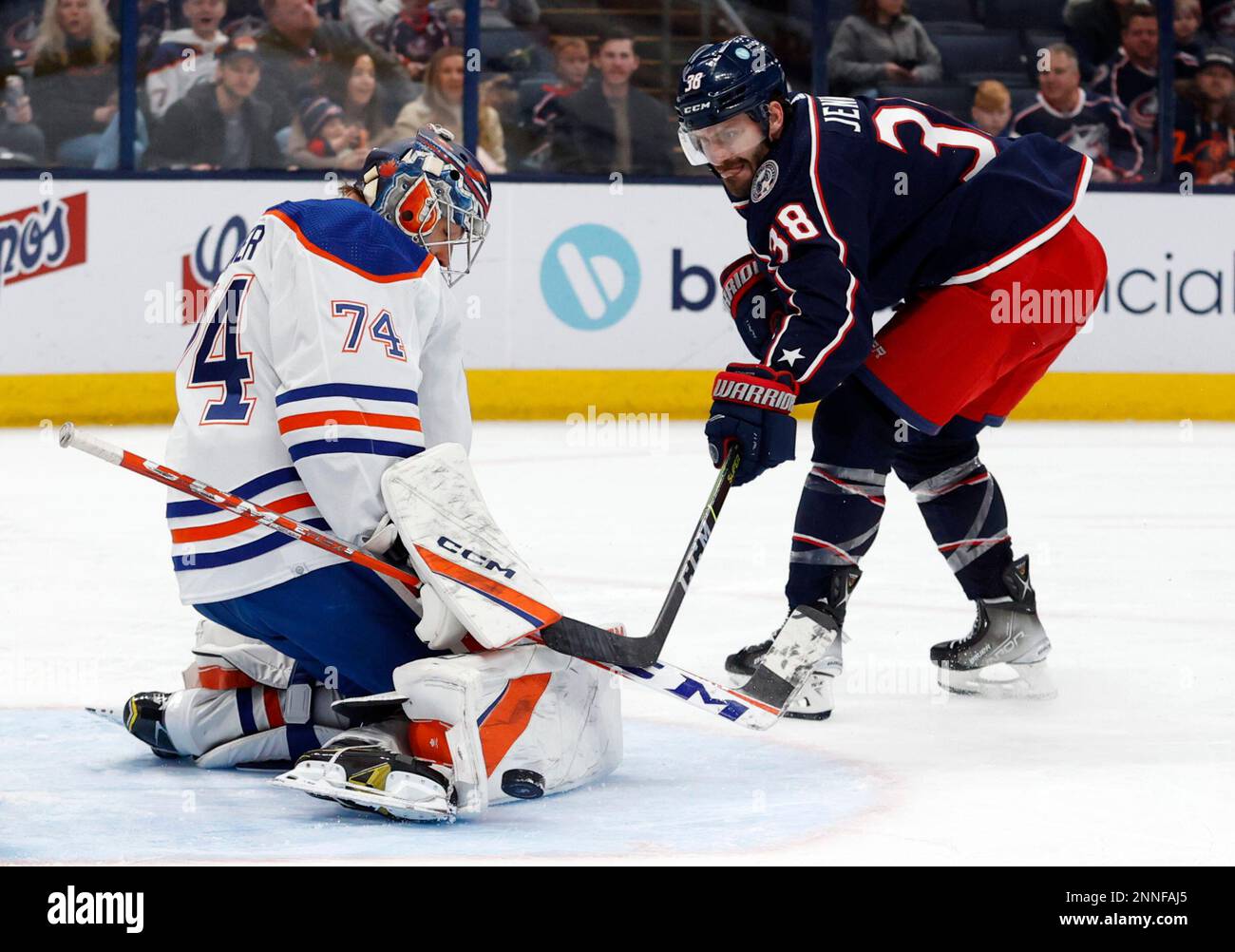 Edmonton Oilers goalie Stuart Skinner, left, stops a shot by Columbus