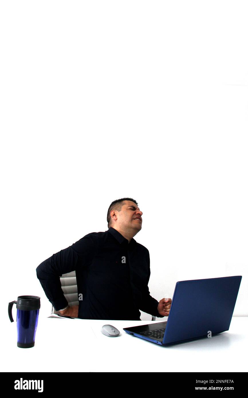 Ein erwachsener Latino-Mann arbeitet in seinem Büro mit seinem Laptop, Kopf, Hals und Rücken, Gebärmutterhals, Lumbale Schmerzen durch Stress, Angst und Spannung Stockfoto
