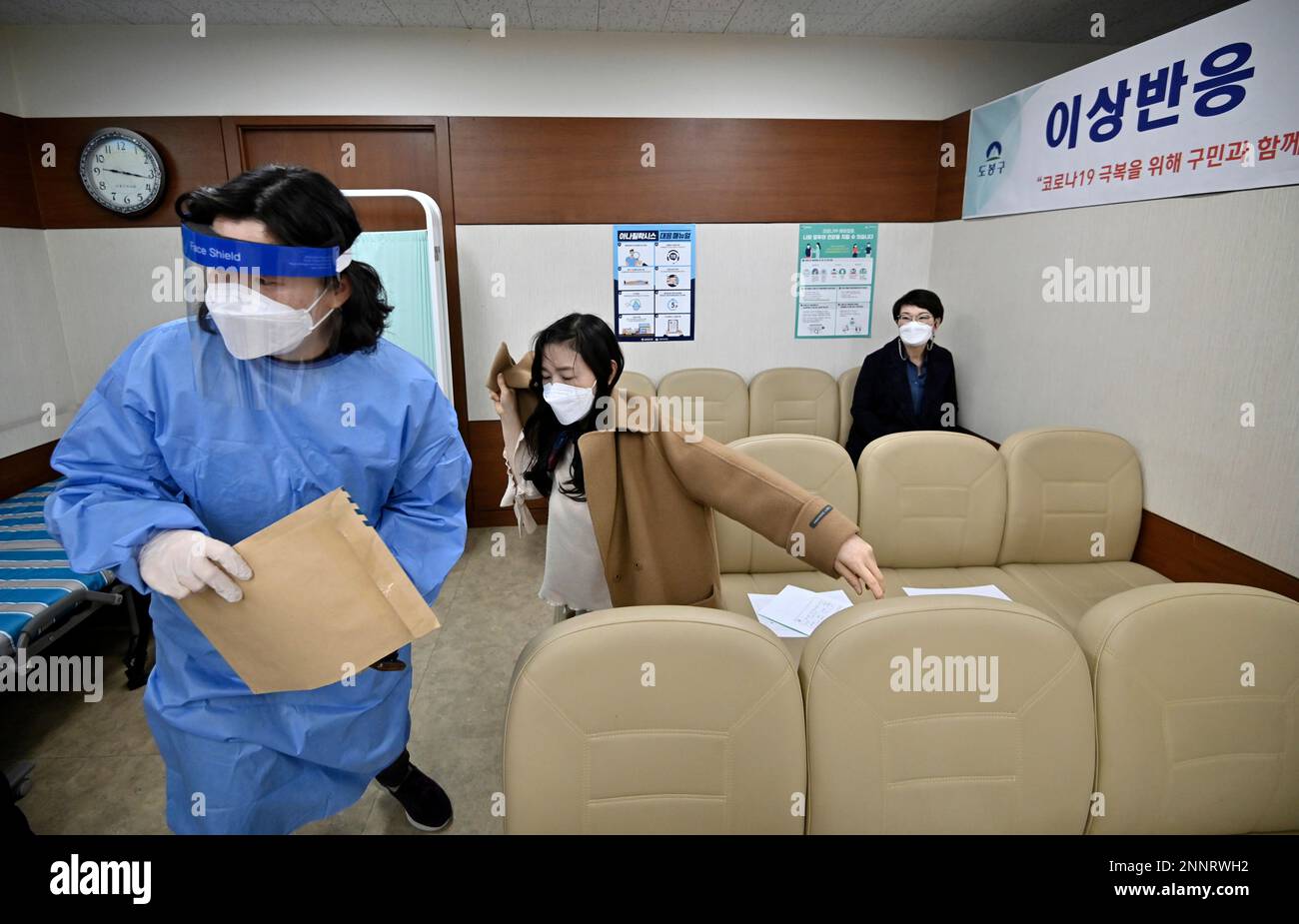 Nursing home workers take a seat after receiving the first dose of the