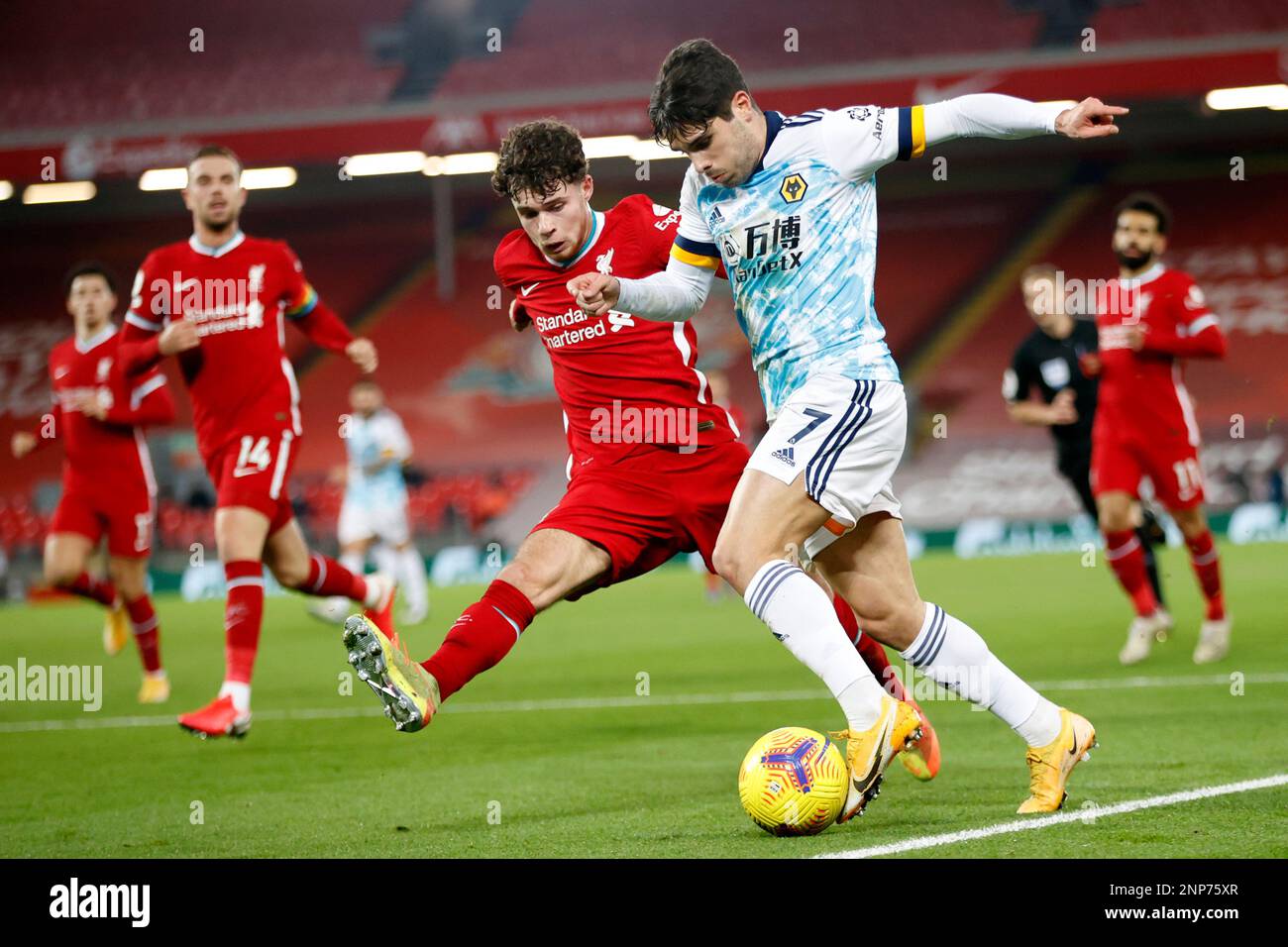 Liverpool's Neco Williams vies for the ball with Wolverhampton Wanderers' Pedro Neto, center right, during the English Premier League soccer match between Liverpool and Wolverhampton Wanderers at Anfield Stadium, Liverpool, England, Sunday, Dec. 6, 2020. (Clive Brunskill/Pool via AP) Stockfoto