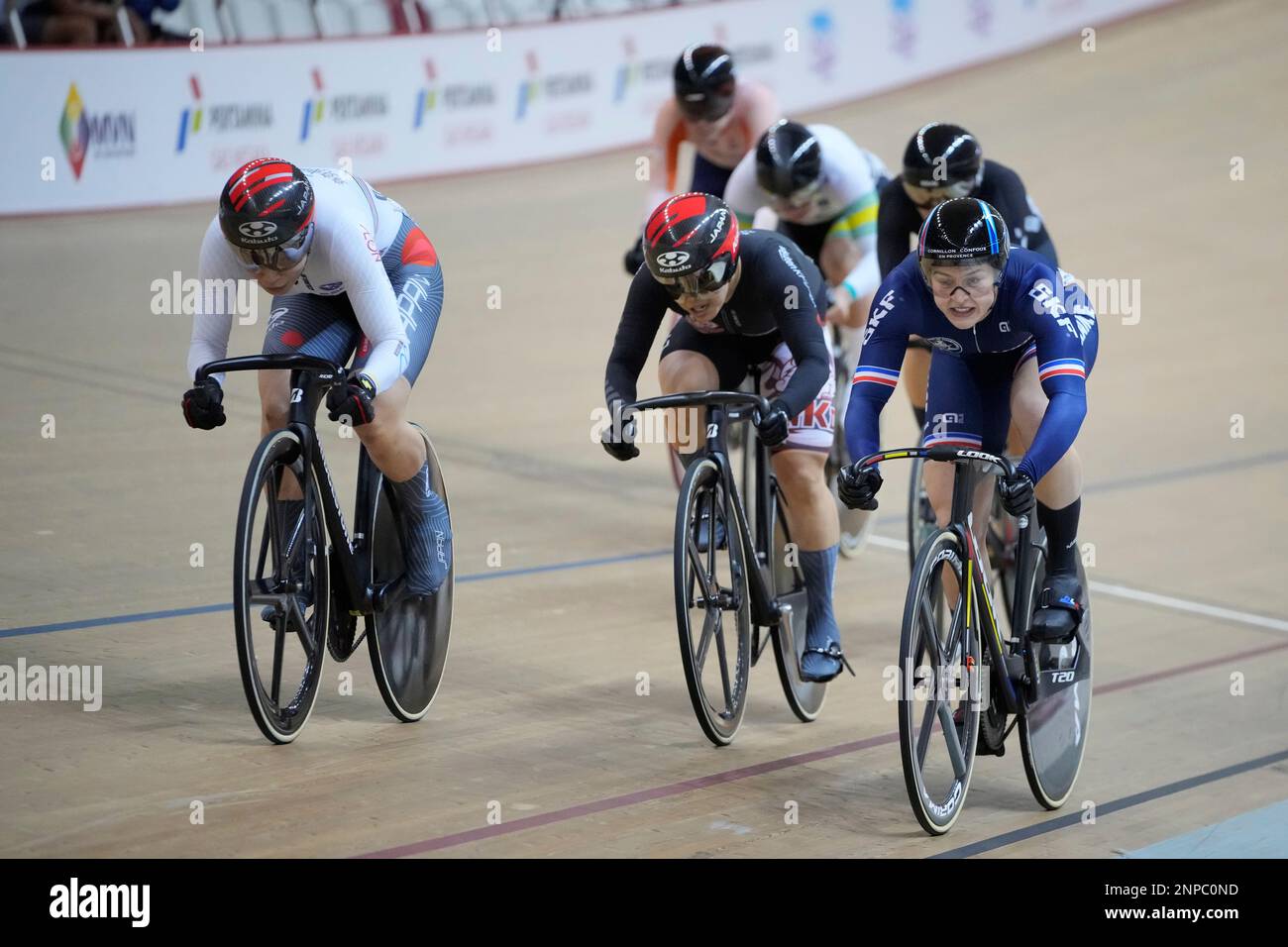 Japan's Mina Sato, left, race against Rakuten K Dream's Fuko Umekawa of Japan, center, and Mathilde Gros of France, right, during the women's keirin final at UCI Track Nations Cup track cycling championship at Jakarta International Velodrome in Jakarta, Indonesia, Sunday, Feb. 26, 2023. (AP Photo/Achmad Ibrahim) Stockfoto