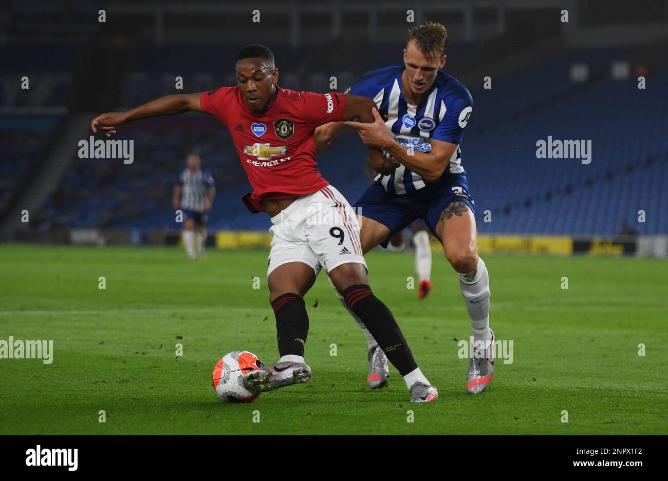Brighton's Dan Burn, right, tries to stop Manchester United's Anthony Martial during the English Premier League soccer match between Brighton & Hove Albion and Manchester United at the AMEX Stadium in Brighton, England, Tuesday, June 30, 2020. (Mike Hewitt/Pool via AP) Stockfoto