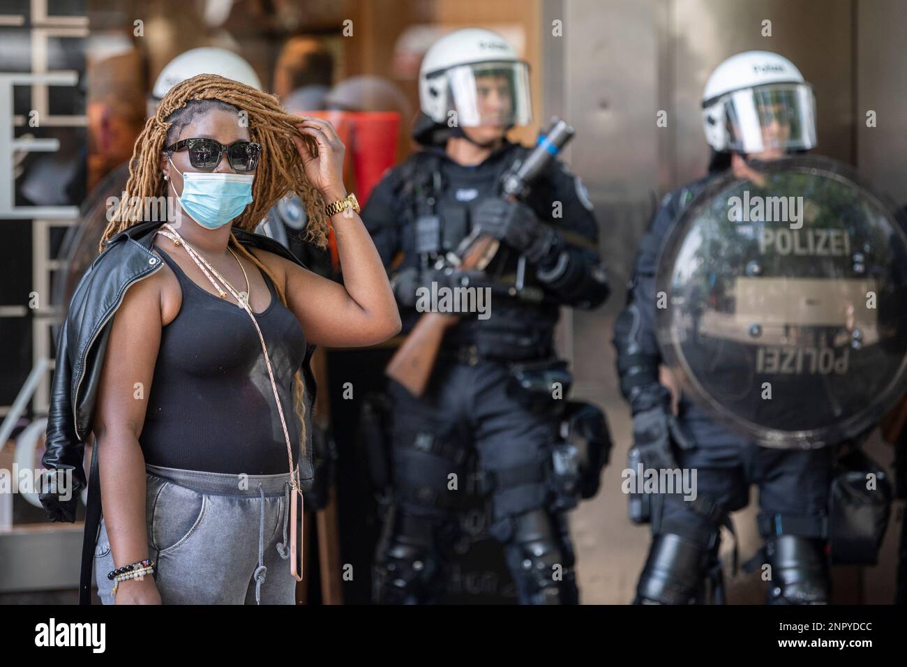 Police Injustice Riot A woman stands in front of riot police officers during a protest ...