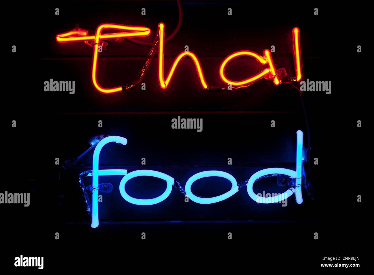 Ein Neonlicht, das in den Ausdruck „thailändisches Essen“ eingeprägt ist. Stockfoto