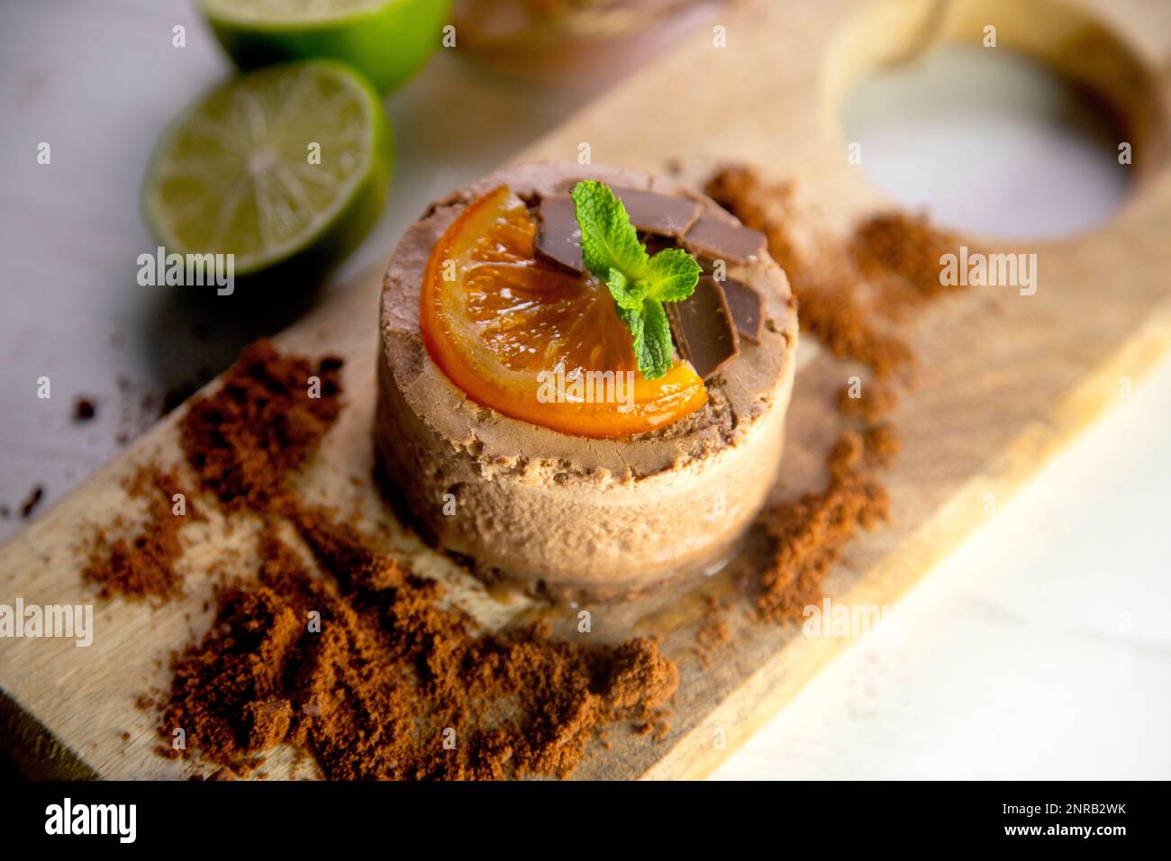 Schokoladen-Mousse-Kuchen mit einem Stück kandierten Orangen-Dekor. Stockfoto