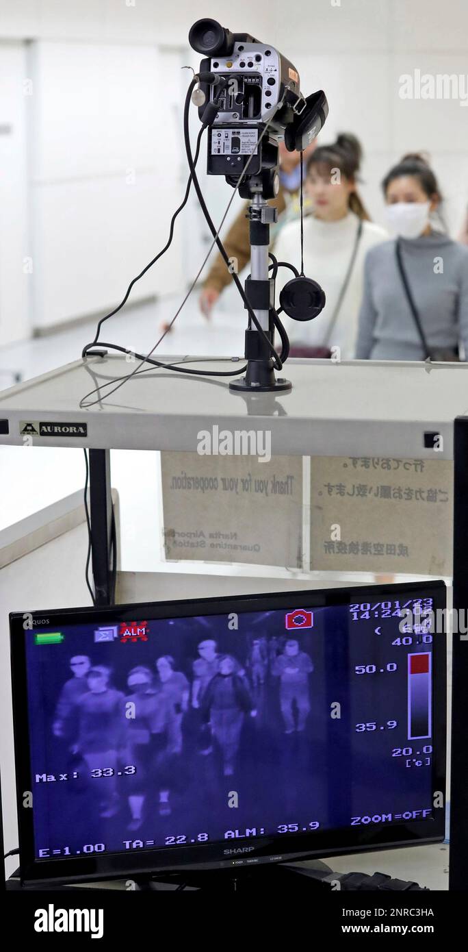 Passengers wearing mask pass near thermography at quarantine inspection