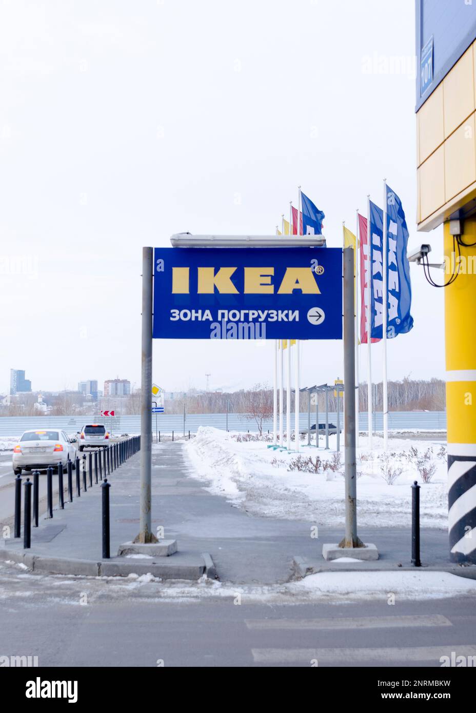 Sicherheitskameras im Ikea-Laden mit einem Zeiger auf den Eingang und den Parkplatz vor dem Hintergrund von Flaggen in Russland. Stockfoto