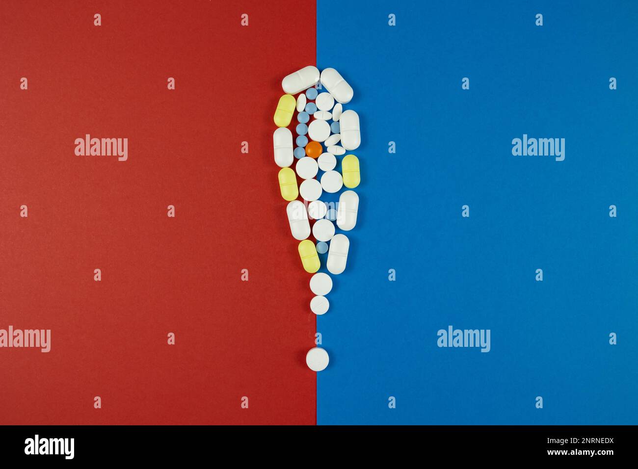 Pillen oder Arzneimittel Nebenwirkungen Konzeptfoto. Warnschild mit isolierten Pillen auf blauem und rotem Hintergrund. Stockfoto