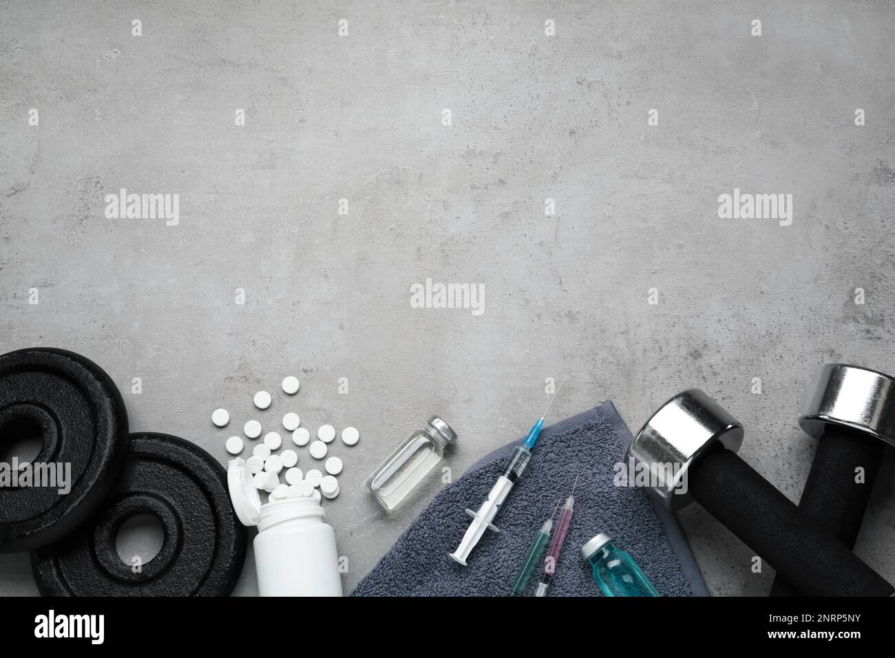 Verschiedene Drogen und Sportgeräte auf grauem Hintergrund, flach liegend mit Platz für Text. Dopingkontrolle Stockfoto