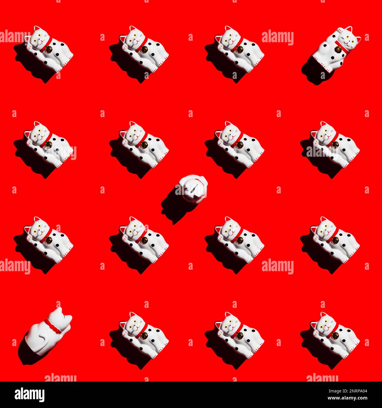 Quadratisches Muster von Maneki-Neko-Katzen auf rotem Hintergrund. Winkende Katze. Die rechte Pfote der Glückskatze ist angehoben. Stockfoto