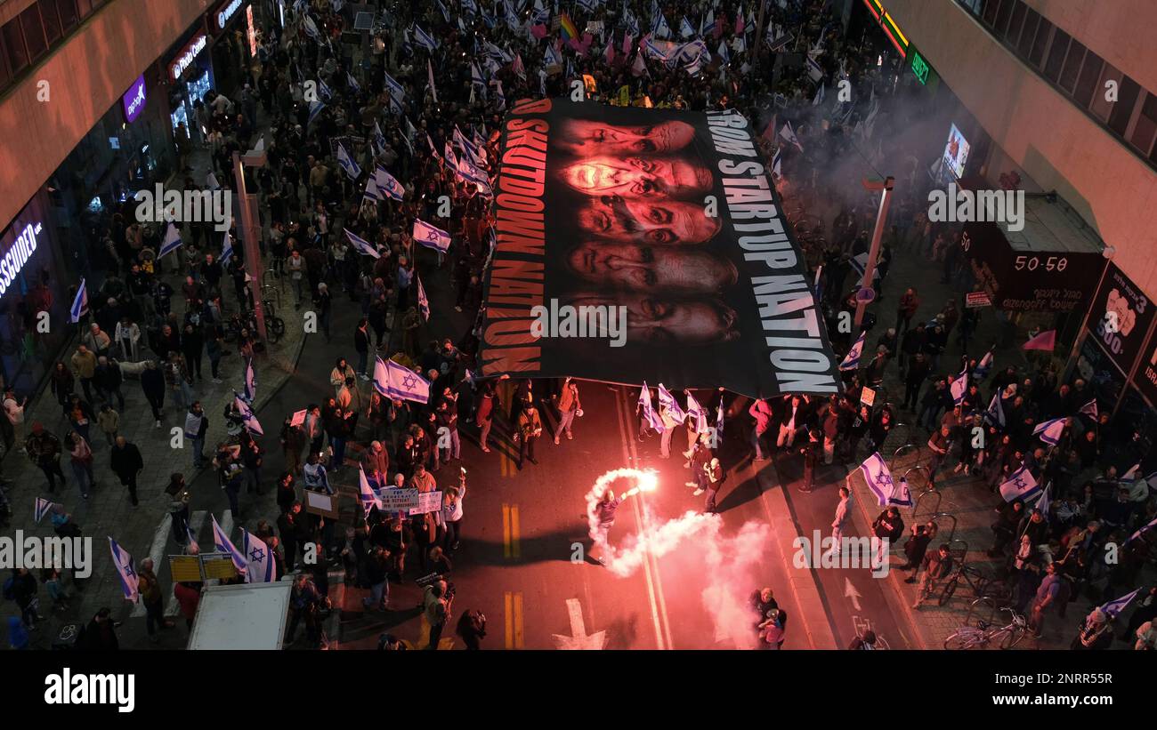 TEL AVIV, ISRAEL - FEBRUAR 25: Regierungsfeindliche Demonstranten lassen ein rotes Fackeln los, da sie ein großes Banner mit einem Porträt von (L-R) dem ehemaligen Obersten Führer des Iran Ruhollah Khomeini, dem ungarischen Premierminister Viktor Orban, dem türkischen Präsidenten Recep Tayyip Erdogan, dem israelischen Premierminister Benjamin Netanjahu, Und der russische Präsident Wladimir Putin während einer Demonstration gegen Israels rechtskräftigen Plan des Justizsystems, der darauf abzielt, den Obersten Gerichtshof des Landes am 25. Februar 2023 in Tel Aviv, Israel, zu schwächen. Zehntausende Kundgebung für die achte Woche in Folge durch Israel gegen die breite Welt Stockfoto