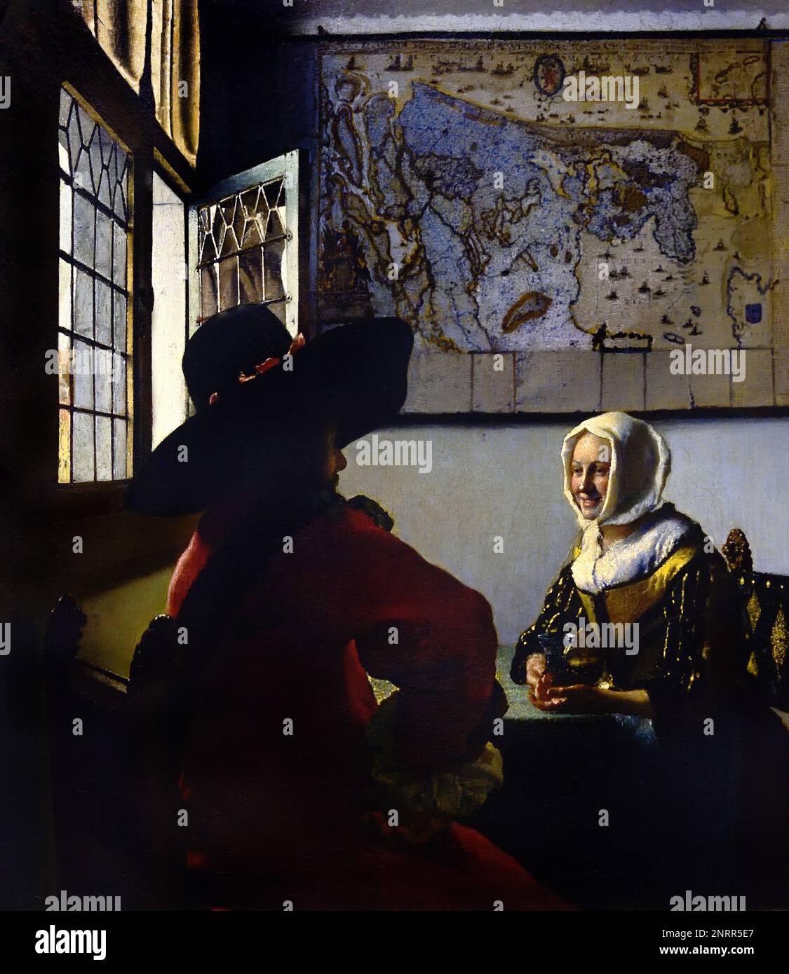 Officer and Laugh Girl 1652-1658 von Johannes Vermeer oder Jan Vermeer 1632 - 1675, Delft, Niederlande, Holländisch, Holland, (Holländischer Maler im Goldenen Zeitalter, einer der größten Maler des 17. Jahrhunderts. Bevorzugte zeitlose, gedämpfte Momente, bleibt rätselhaft, unnachahmliches Farbschema und verwirrender Lichtinhalt) Stockfoto