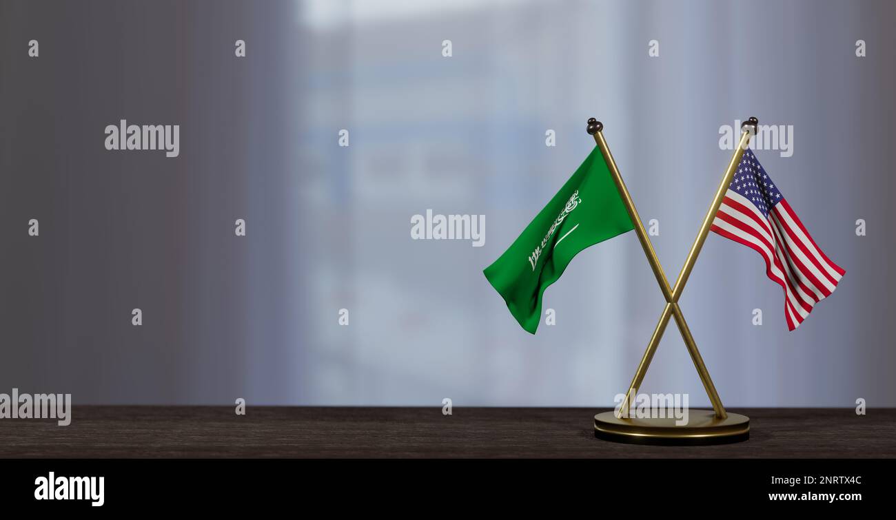 Flaggen Saudi-Arabiens und der USA auf dem Tisch. Verhandlungen zwischen Saudi-Arabien und den Vereinigten Staaten. Auf wenig unscharfem Hintergrund. 3D Arbeit und 3D Bild Stockfoto