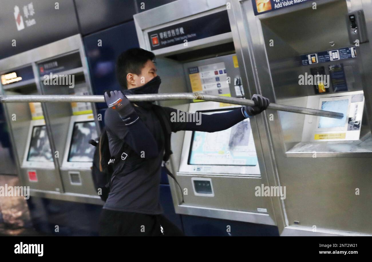 Protesters break the ticket vending machine at Tung Chung station, near