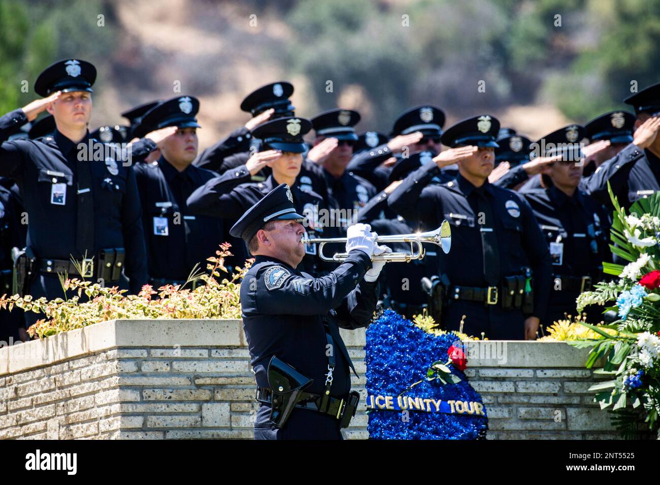 Law enforcement personnel salute at the funeral of Los Angeles Police ...