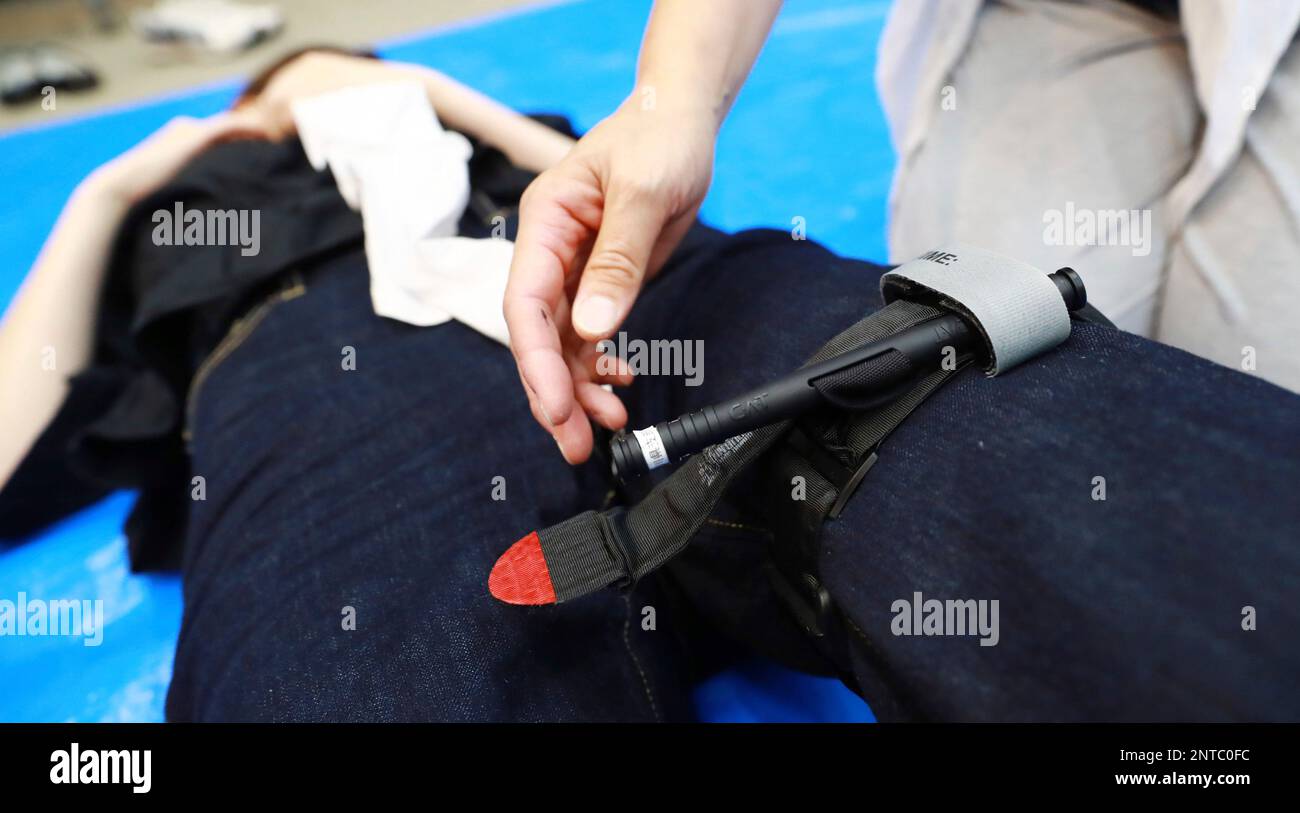 Participants learn how to use a tourniquet during first aid training at Japanese Red Cross