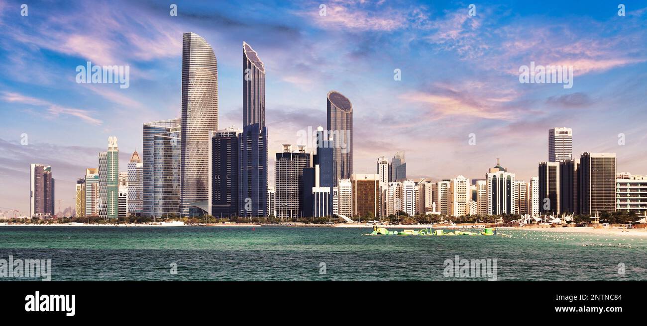 Skyline von Abu Dhabi mit Reflexionen im Meer, Vereinigte Arabische Emirate - Panorama Stockfoto