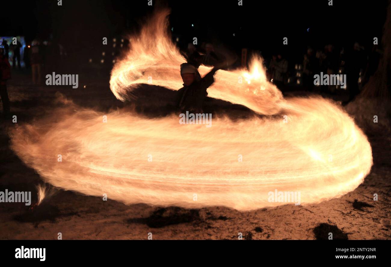 Performers swing bales of burning straw to creat a fire ring during the ...