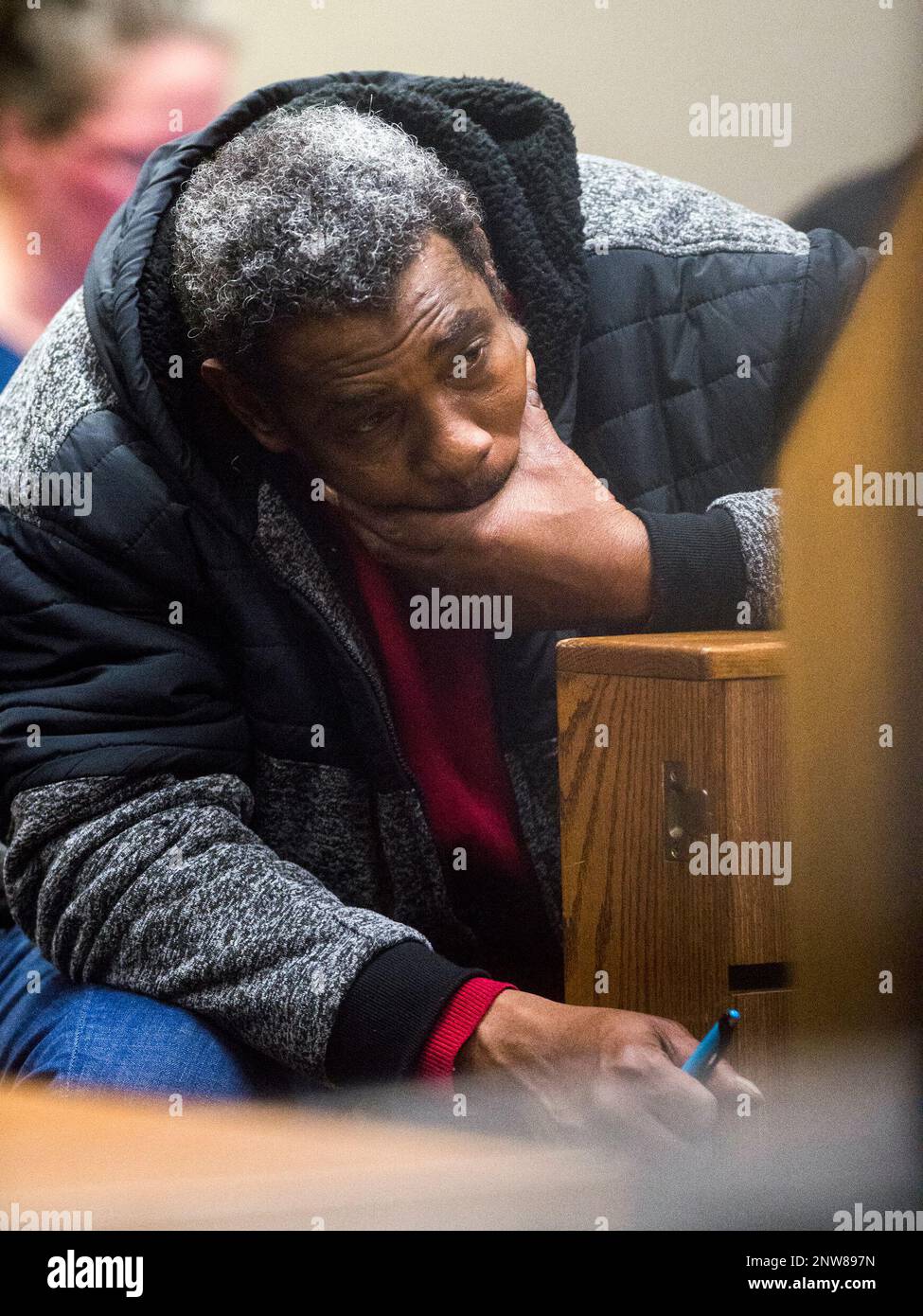 A Flint resident listens from the gallery during a hearing on Dr. Eden