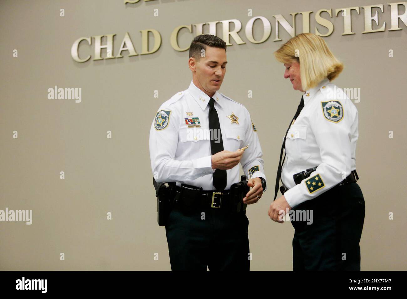 Hillsborough County Sheriff Chad Chronister, left, gives his Chief