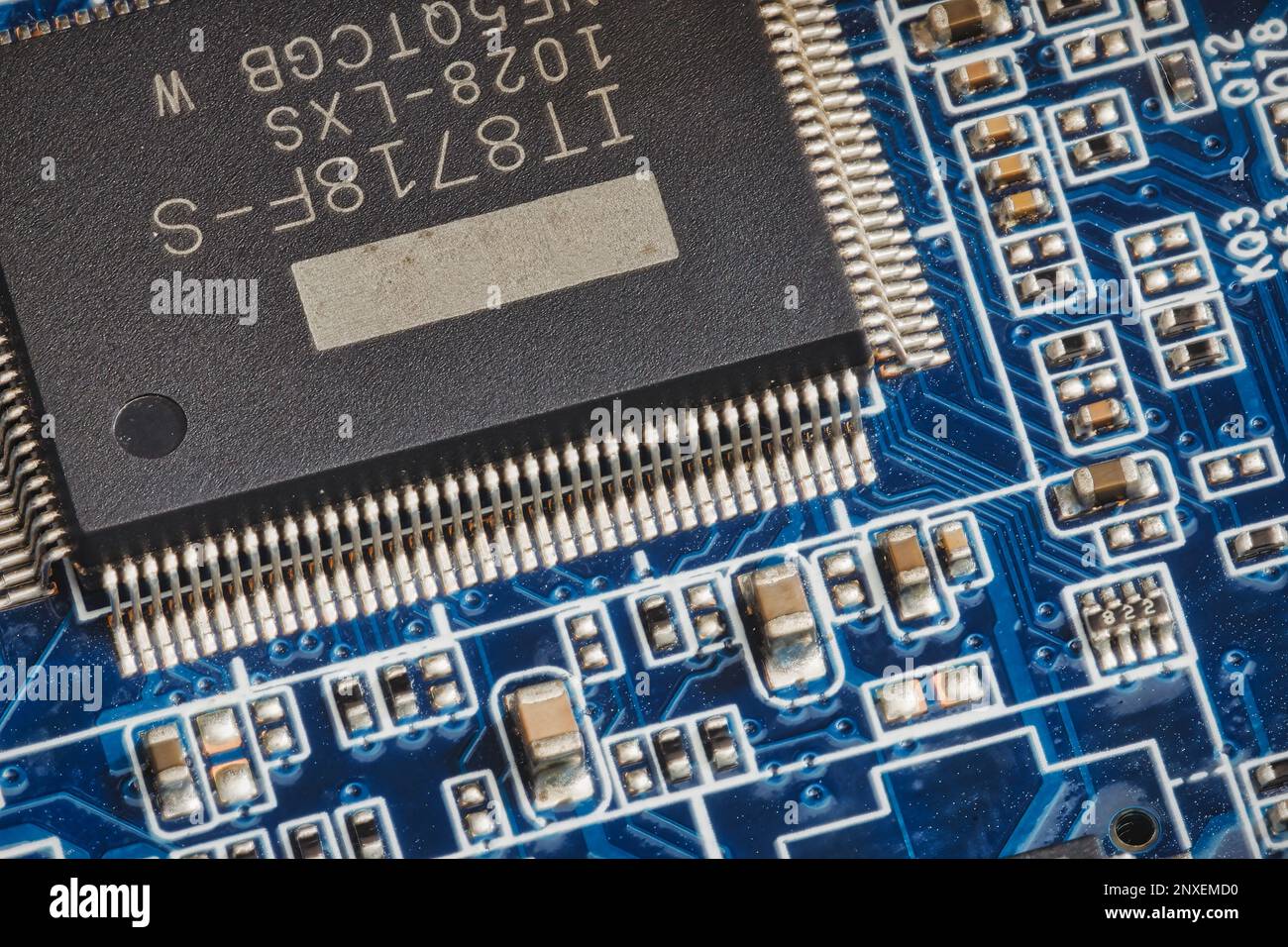 Nahaufnahme einer blauen Leiterplatte mit elektrischen Komponenten und Mikrochip Stockfoto