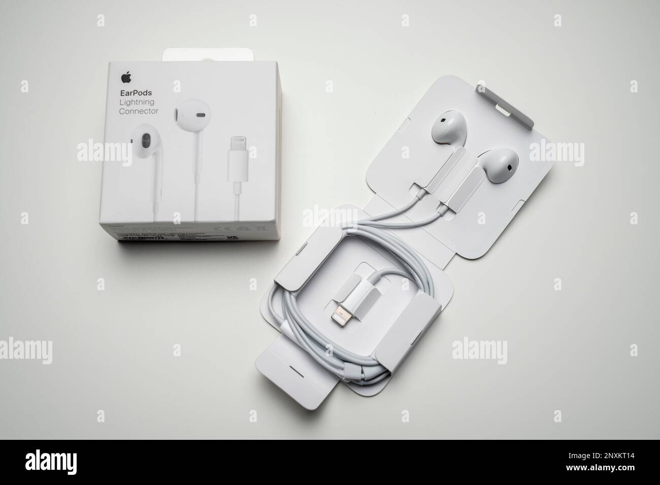 Neue Apple-Ohrhörer, AirPods-Kopfhörer in Weiß für die Wiedergabe von Musik und Podcasts in einer offenen Verpackung. Isoliert auf weißem Hintergrund. Budapest, Ungarn - Feb Stockfoto