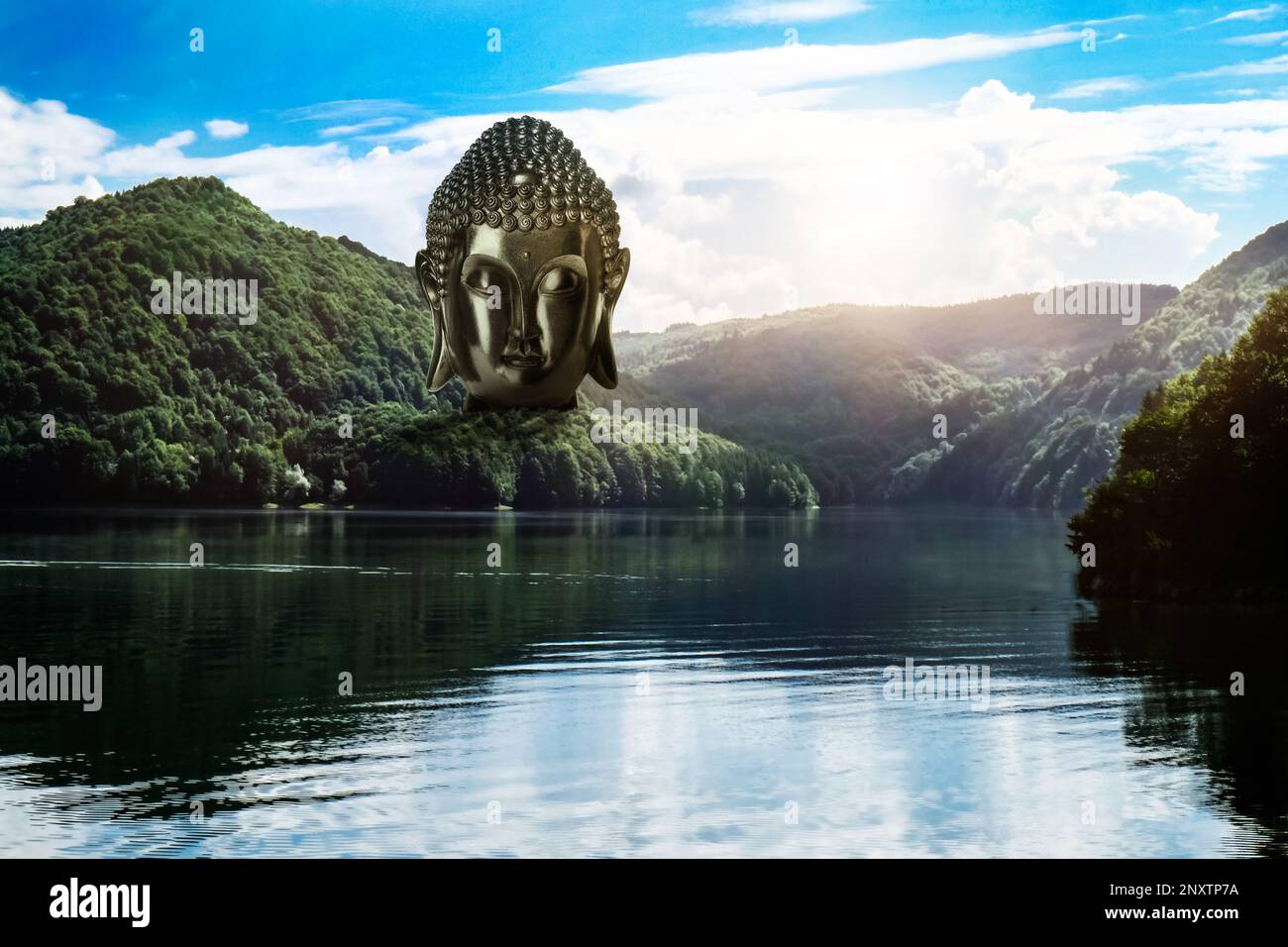 Majestätische Buddha-Skulptur in der Nähe des Sees und der Berge an sonnigen Tagen Stockfoto