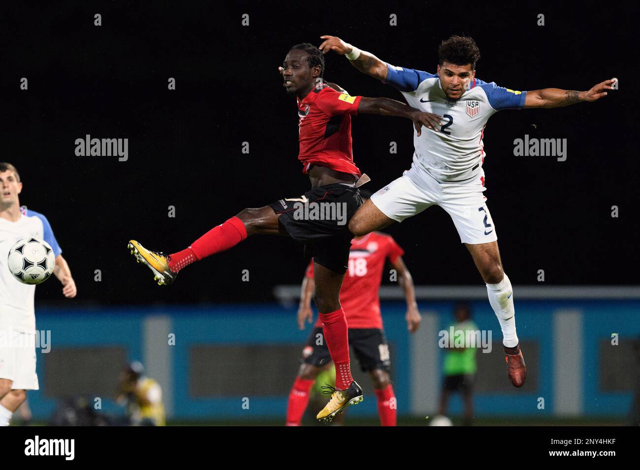 Trinidad' Nathan Lewis (7) and United States' DeAndre Yedlin (2) jump for the ball during a FIFA World Cup qualifying soccer match. Tuesday, October 10, 2017 in Port of Spain, Trinidad. Trinidad and Tobago won 2-1. (TFV Media via AP) Stockfoto