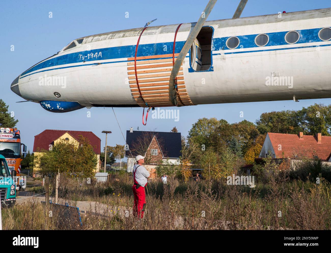 After months of preparation, airplane experts load the fuselage of a ...
