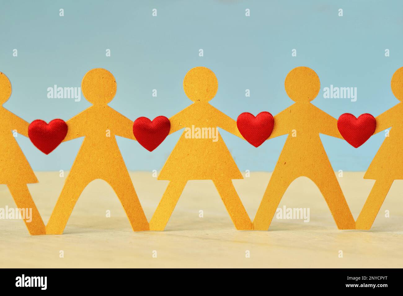 Papiermenschenkette mit Herzen - Konzept von Liebe und Einheit Stockfoto