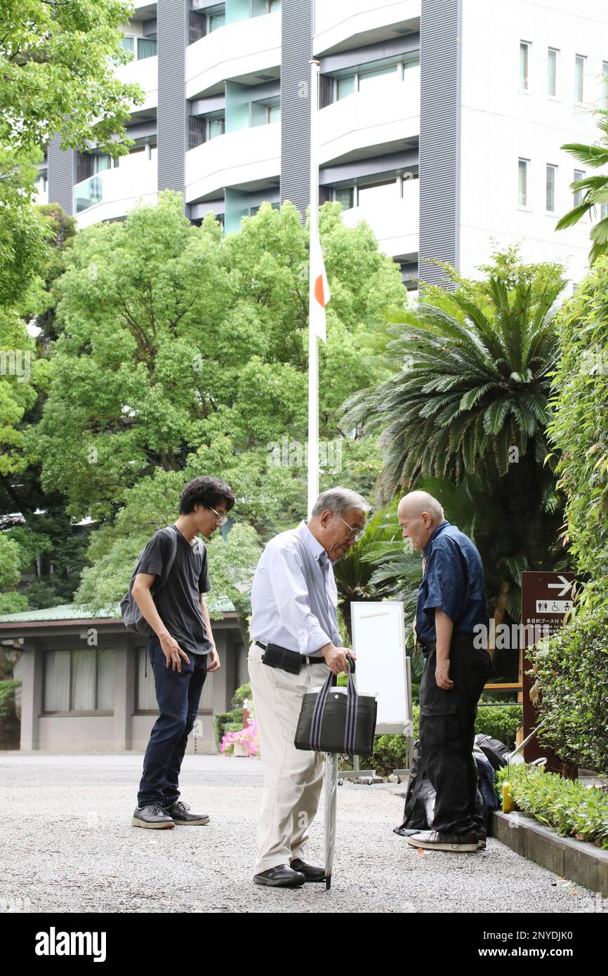 People listen to the radio for hearing Japanese Emperor Akihito and