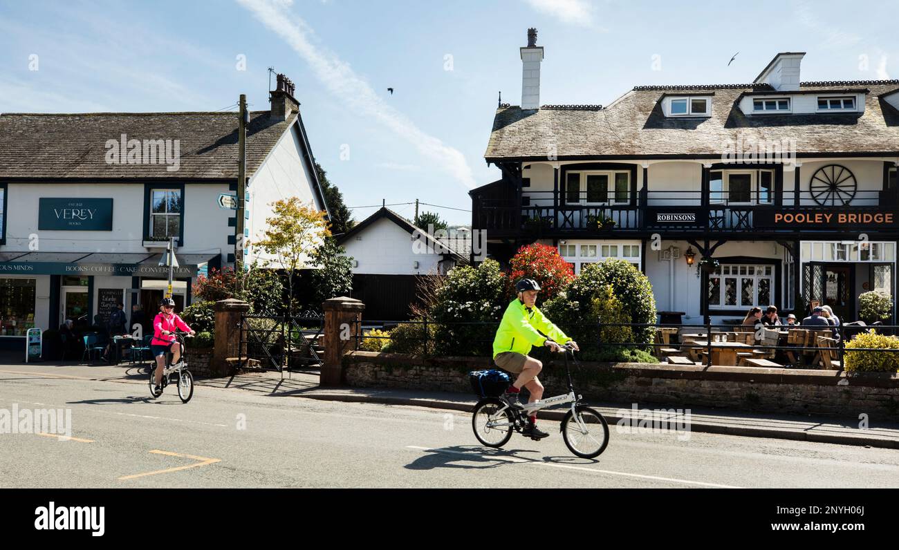 Touristen genießen den Sonnenschein an der Pooley Bridge Ullswater, dem Lake District, Cumbria Stockfoto